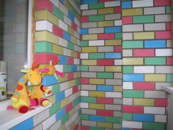 Пример стены, на которой кирпичи покрашены в разные цвета
